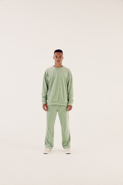 male model in sage reversible tracksuit
