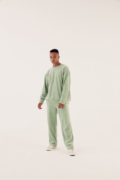 male model in sage reversible tracksuit