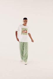 male model in sage reversible tracksuit bottoms and brand carrier tee