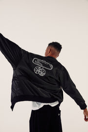 male model from behind wearing satin bomber jacket