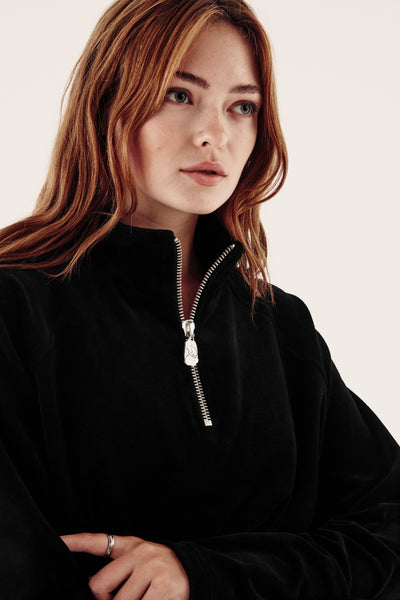 female model in black velour zip fleece