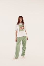 female model in brand carrier tee and sage reversible tracksuit bottoms